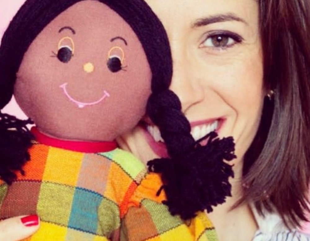 Sol Piñero Misa smiling cheek to cheek with a handmade rag doll