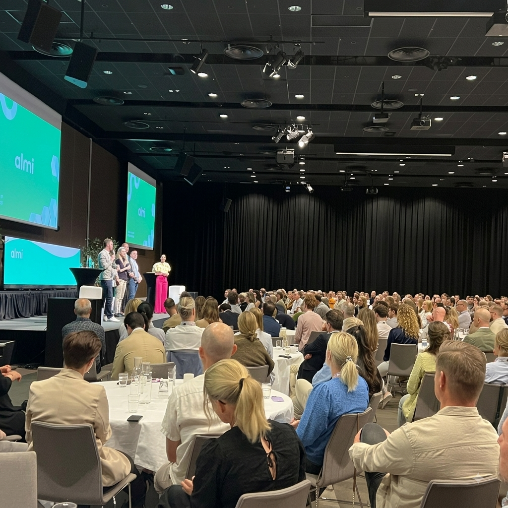 A conference in full flow — Sol on stage with a panel, full room of seated participants