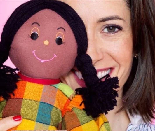 Sol Piñero Misa smiling cheek to cheek with a handmade rag doll
