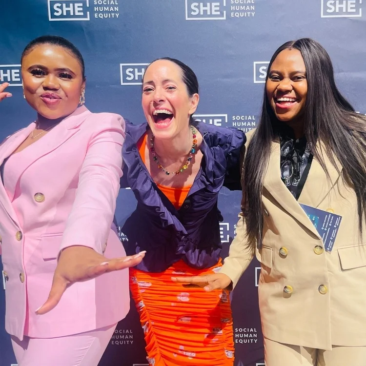 Sol Piñero Misa laughing with two colleagues at a Social Human Equity event